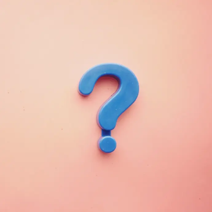 a blue question mark on a pink background