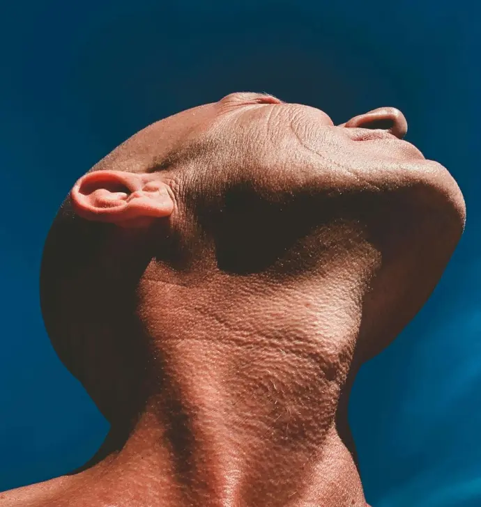 a man's head with a blue background